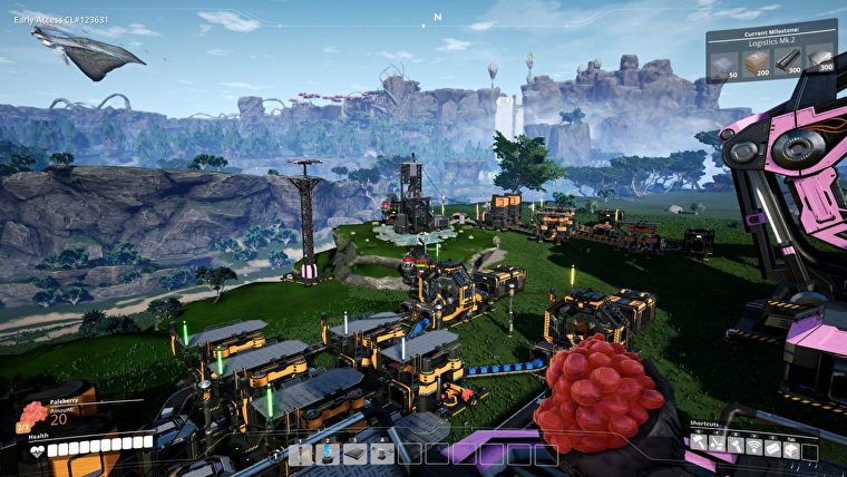Una captura de pantalla que muestra una fábrica bastante extensa que comienza a crecer en el hermoso paisaje en Satisfactory.